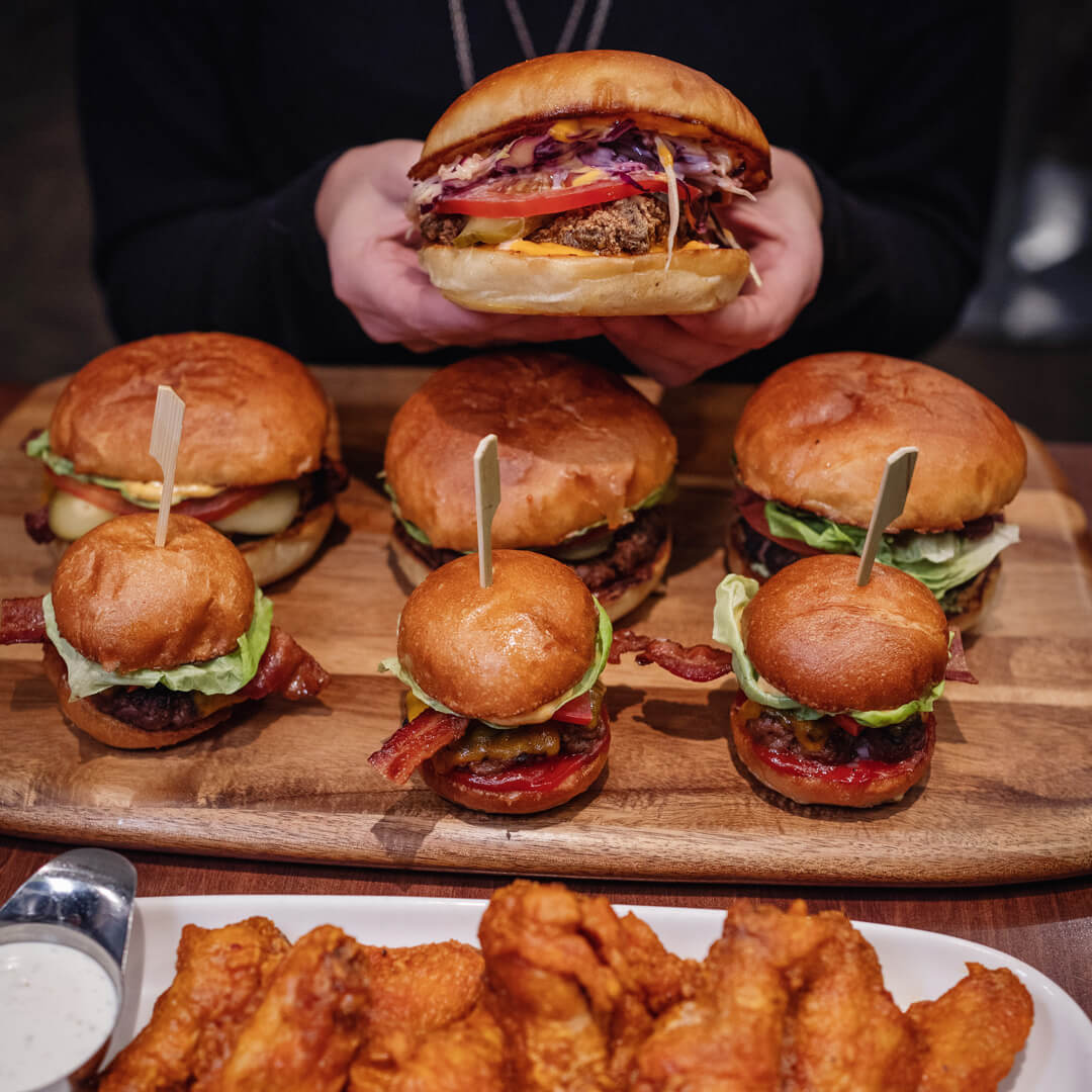 A large share plate of mini-burgers