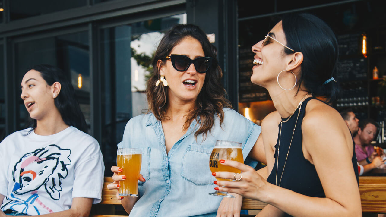 A group of happy pub-goers sitting outisde