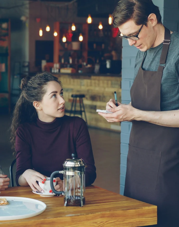 Waiter taking a guest's order at the table