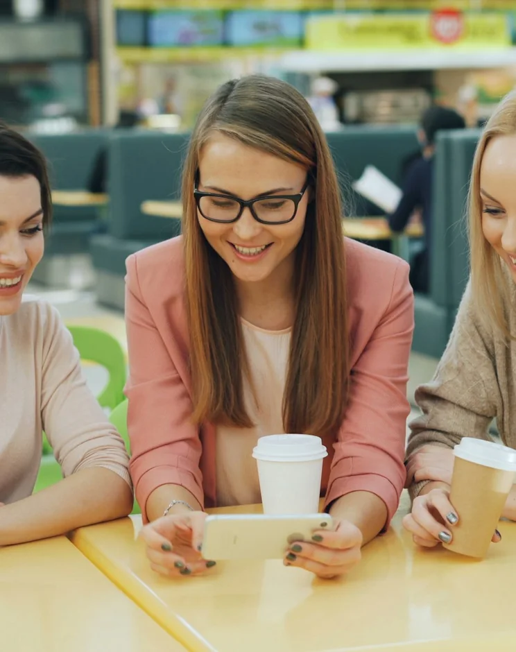 Friends in a café building a group order together