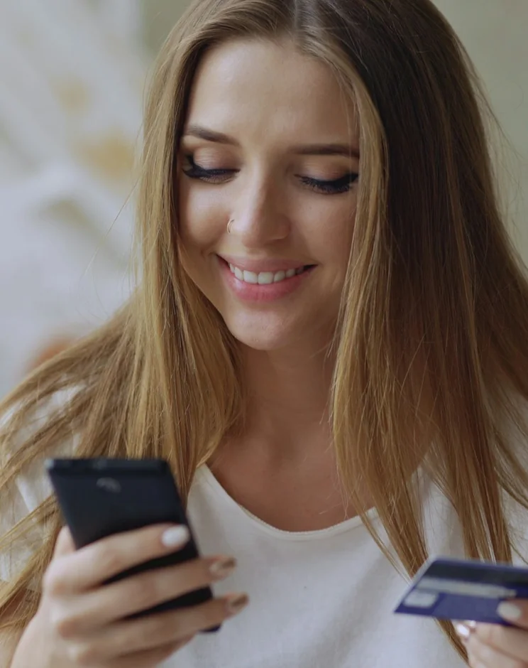 Customer paying for an online order on her phone with a bank card